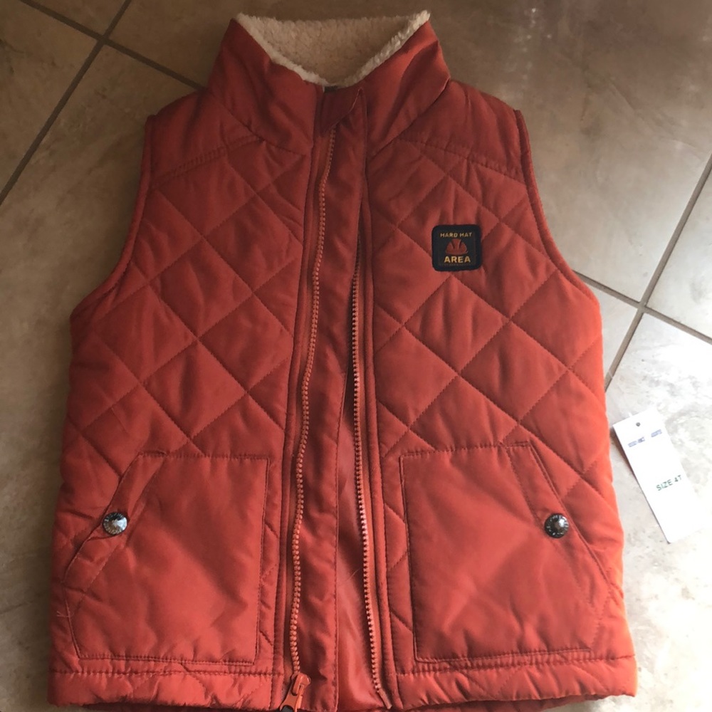 Orange rust colored vest.